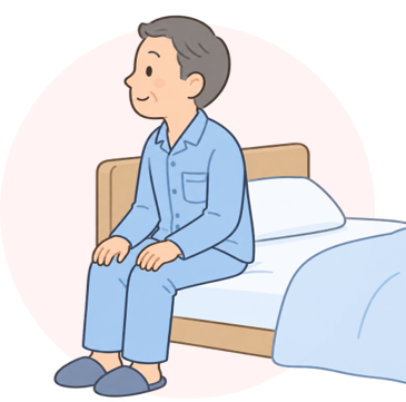 画像:ベッドに腰掛ける男性